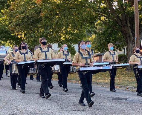 LHS percussion march down neighborhood streets to play for Lancaster residents. 
