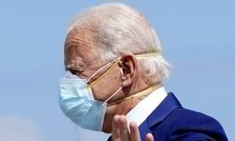President Biden double masking. Photo courtesy of The Guardian.
