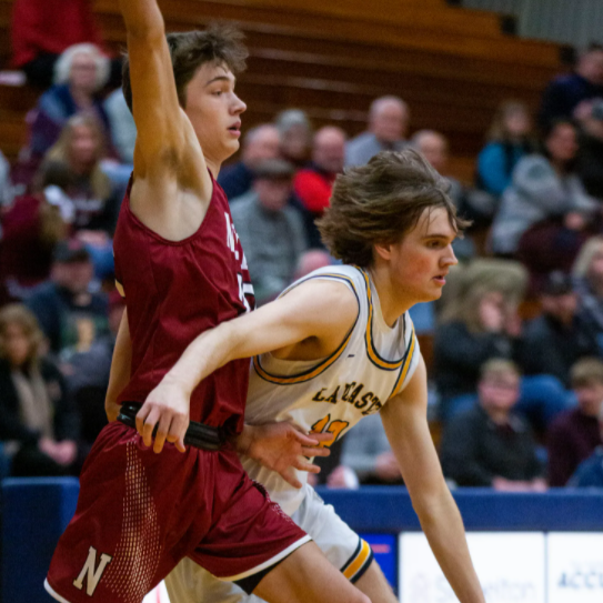 Senior Corbin Hietikko driving past a Newark defender. Photo courtesy of Lancaster Eagle Gazette.