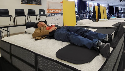 Sophomore Auston Troyer tries out a mattress at the annual LHS Band Mattress Sale.
