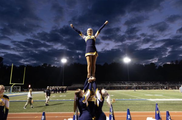 2023-2024 Varsity cheerleaders work to perfect a new stunt.
