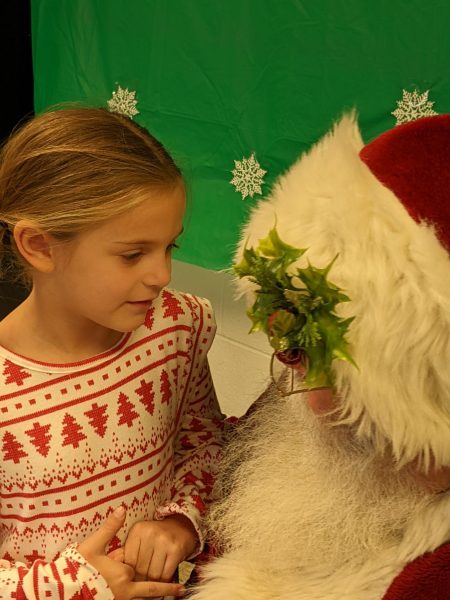 A local child visits with Santa during the annual Gift of Time program at LHS.