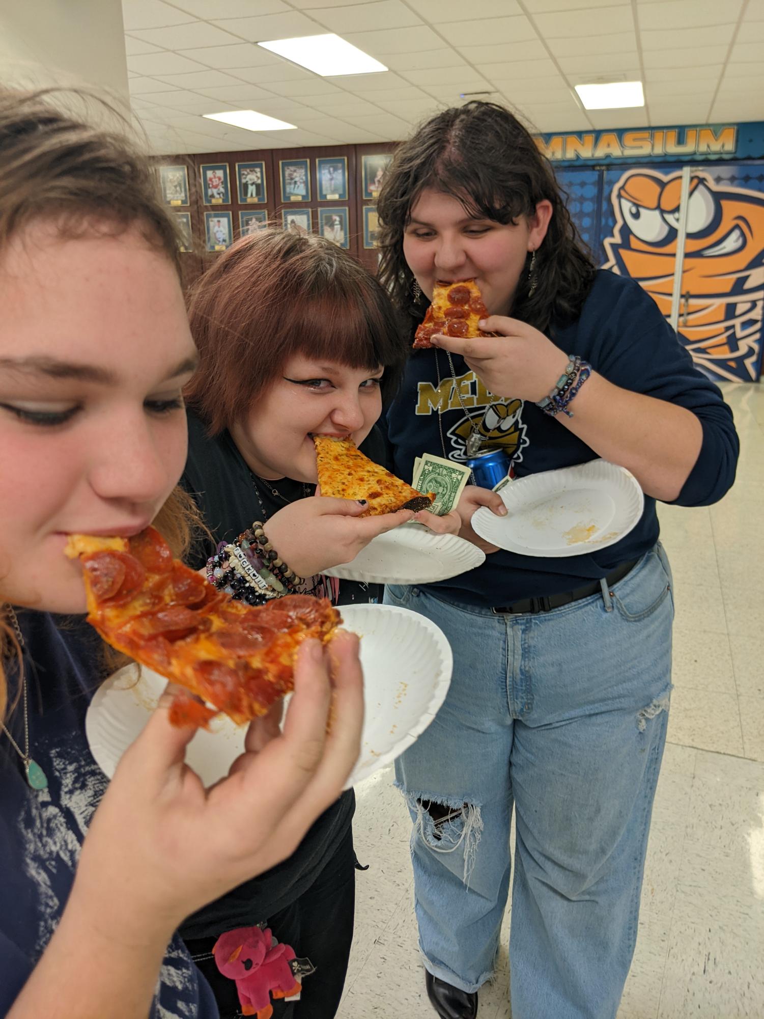 LHS sophomores Tristin Homoelle,Toby McManus, and Madison Hall enjoy pizza during the Gales Grub event.
