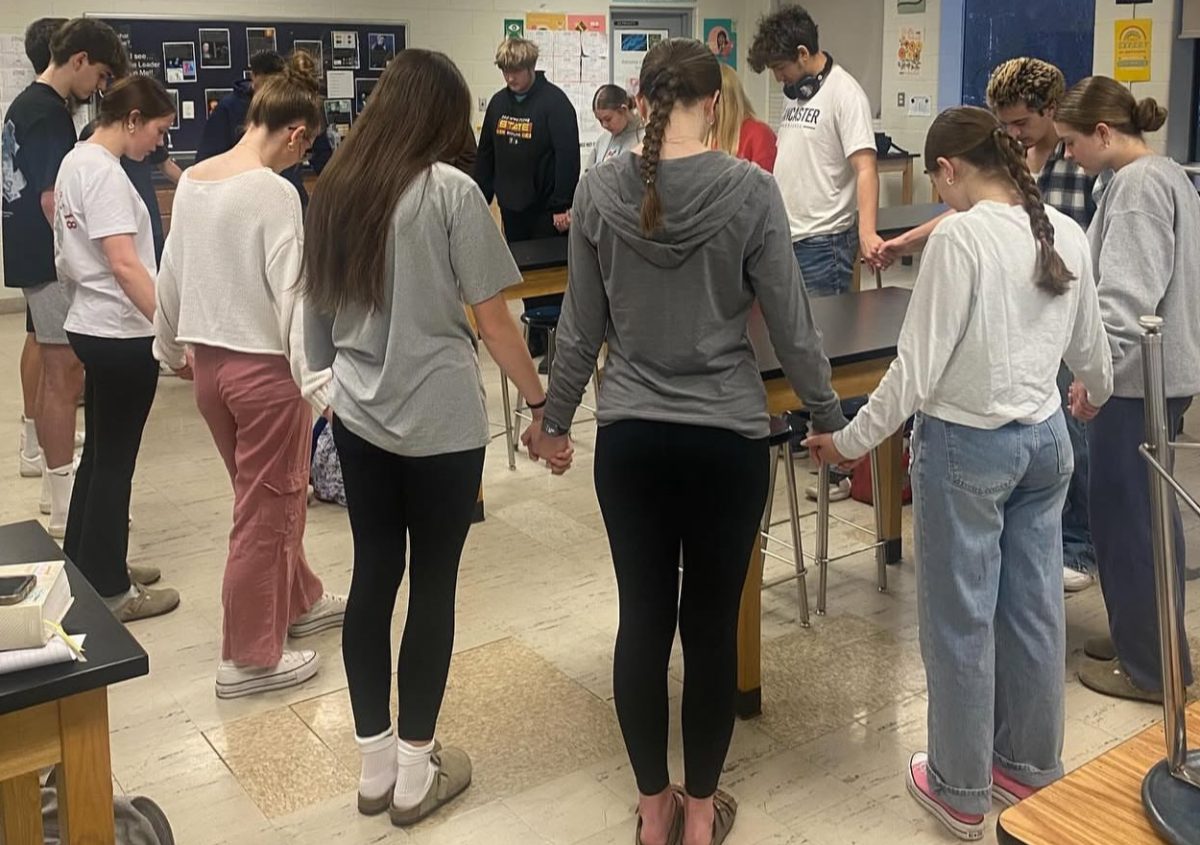 First Priority gathered in a prayer circle. Photo courtesy of First Priority Instagram. 
