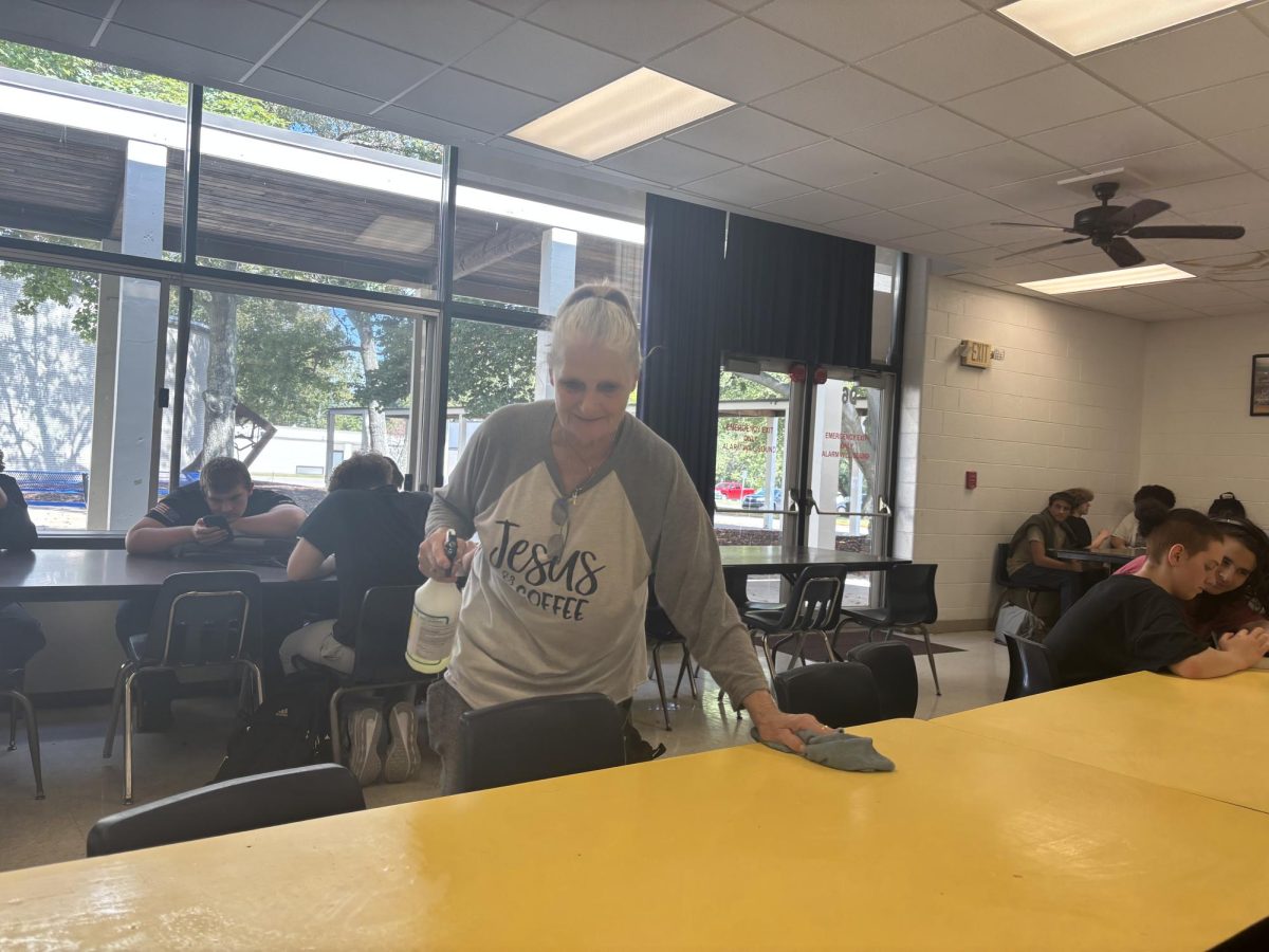 “Grandma” makes sure tables are clean for her students.