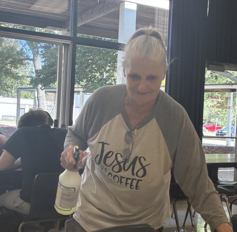 “Grandma” makes sure tables are clean for her students.