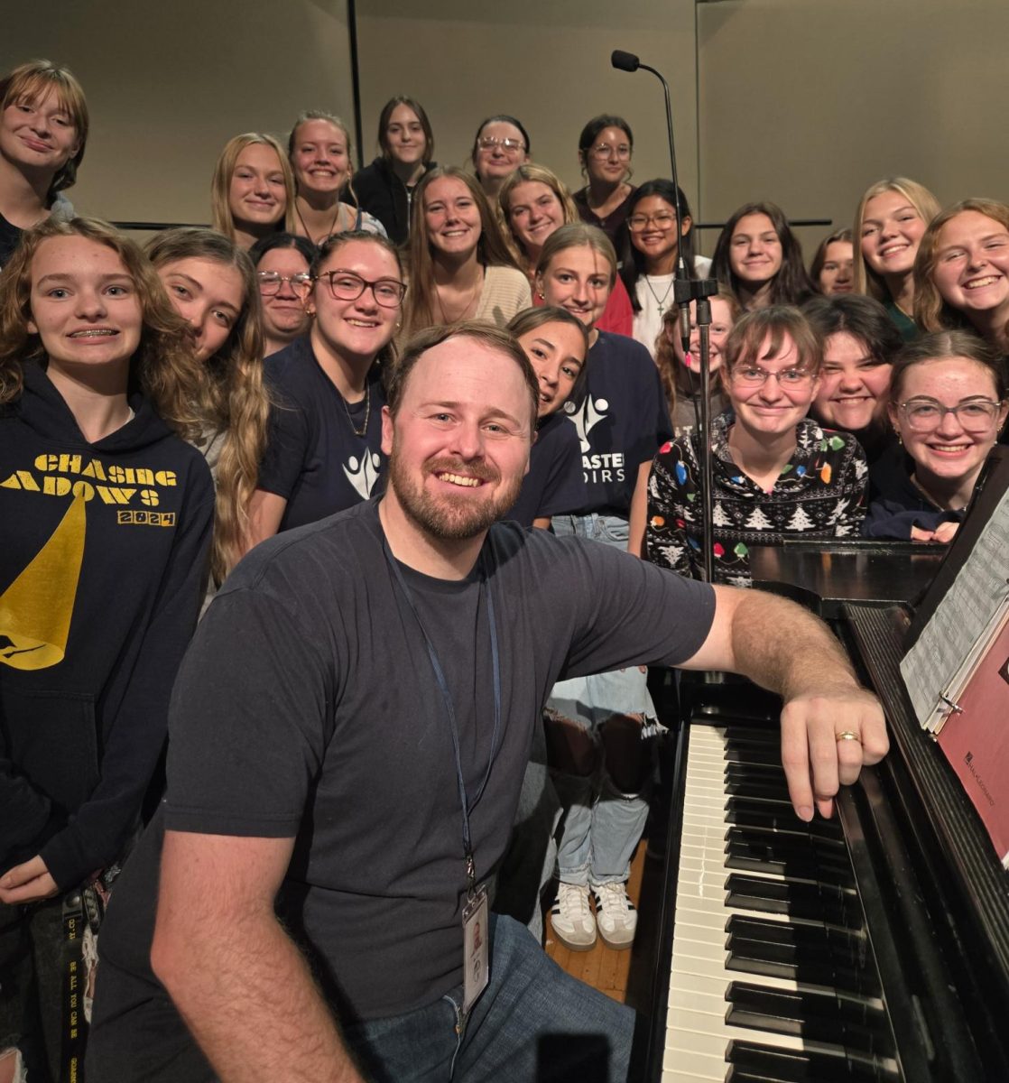 New LHS choir director Hunter John surrounded by LHS students.