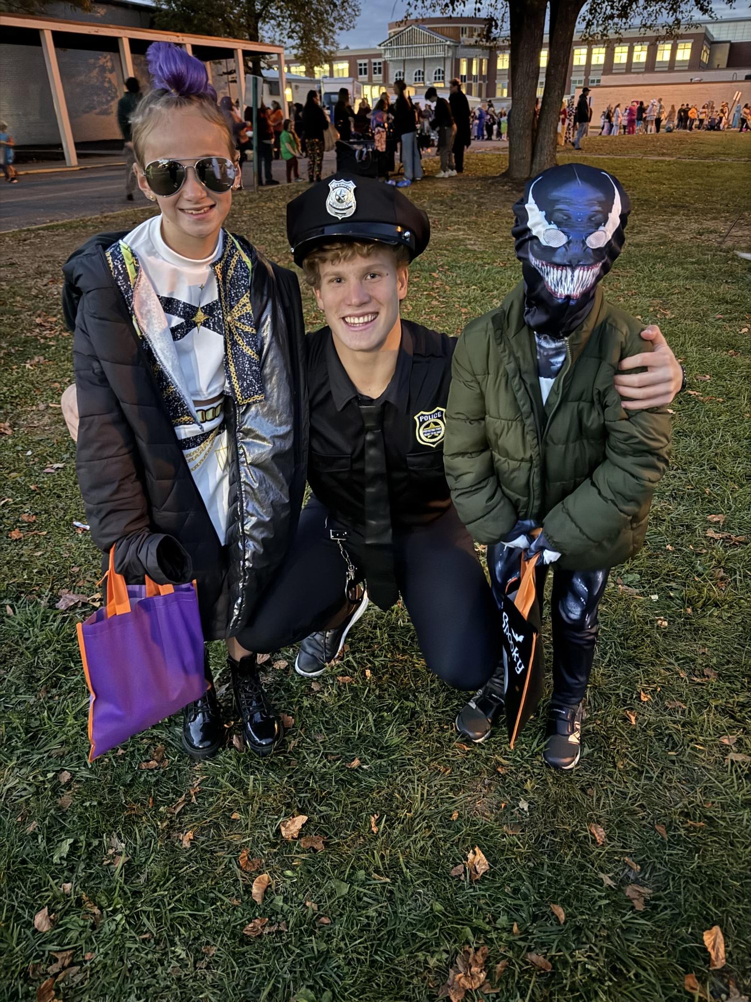 LHS senior Hunter Metz poses with his two young cousins at Ghoulish Gales.
