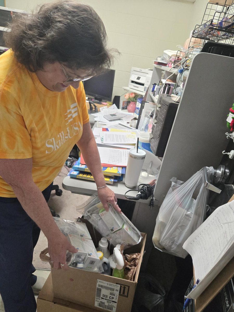 LHS Cosmetology instructor Leah Morgan packs school materials.